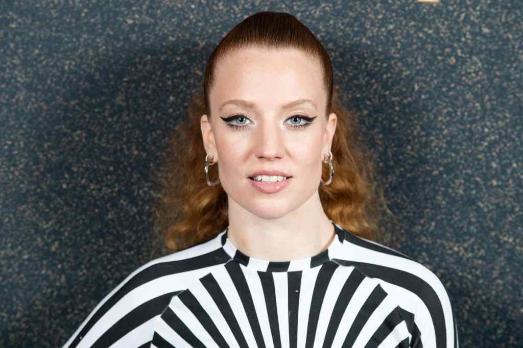 Jess Glynne wearing a black and white dress