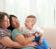 Two women holding a baby