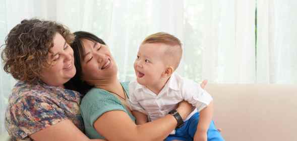 Two women holding a baby