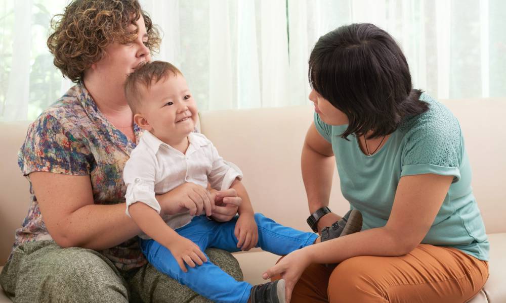 lesbian mothers playing with child