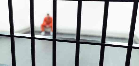 prisoner behind bars