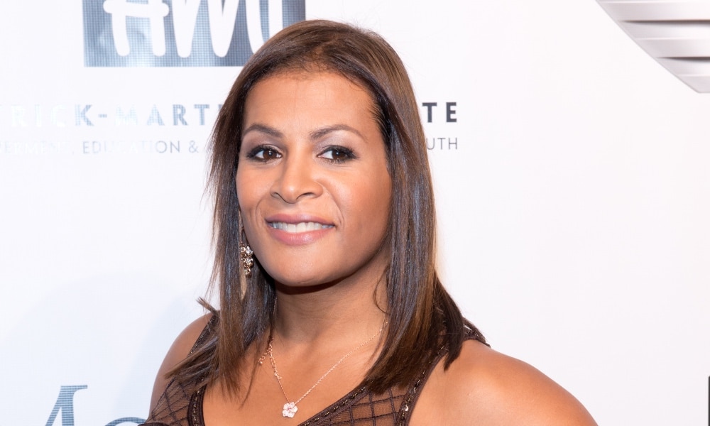 Fallon Fox poses in a brown lace dress