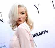 Courtney Stodden poses to the camera on the red carpet in a light pink shirt