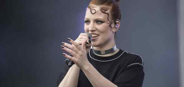 Jess Glynne sings into the microphone