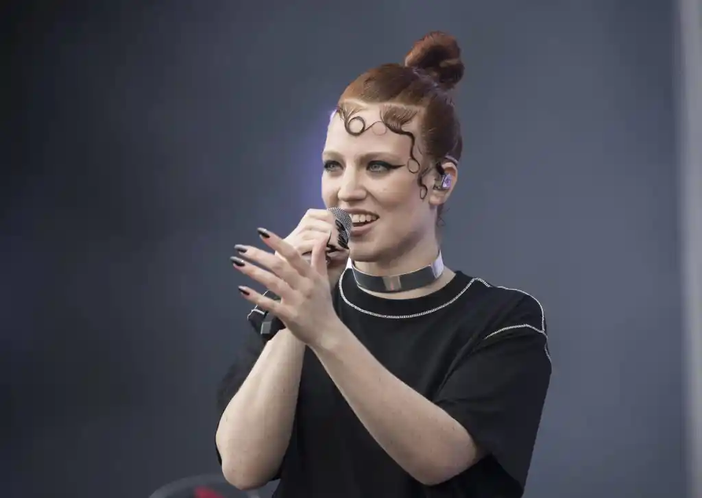Jess Glynne sings into the microphone