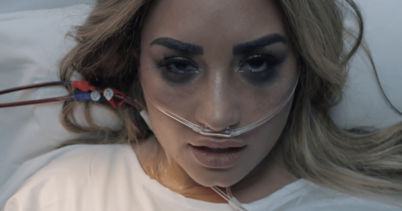 Demi Lovato sings from a hospital bed in her new "Dancing With The Devil" music video