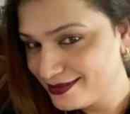 Ekta Joshi smiles to the camera, her hair to the side