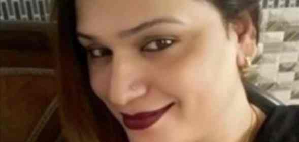 Ekta Joshi smiles to the camera, her hair to the side