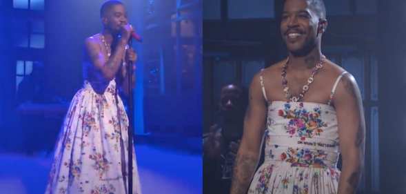 Kid Cudi performs on-stage in a white floral dress