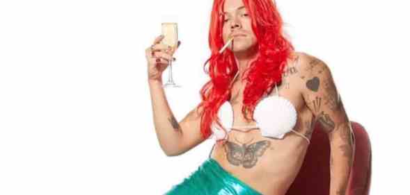 Harry Styles in an Ariel costume, a cigarette in his mouth and holding a flute of champagne