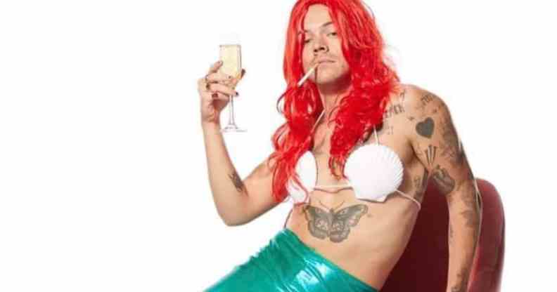 Harry Styles in an Ariel costume, a cigarette in his mouth and holding a flute of champagne