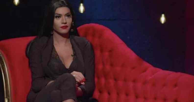 Çağla Akalın sits on a plush red couch