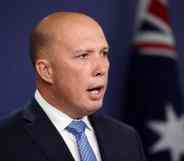 Peter Dutton speaks in a suit