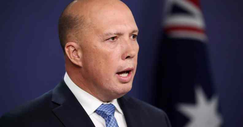 Peter Dutton speaks in a suit