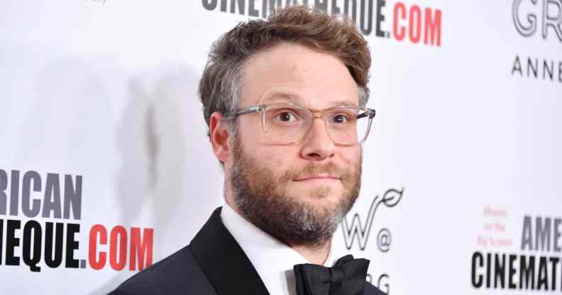 Seth Rogen wearing a tuxedo and a pair of glasses on the red carpet