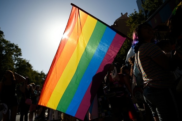 Participants wave a rainbow flag during the 2019 Gay Pride parade in Barcelona