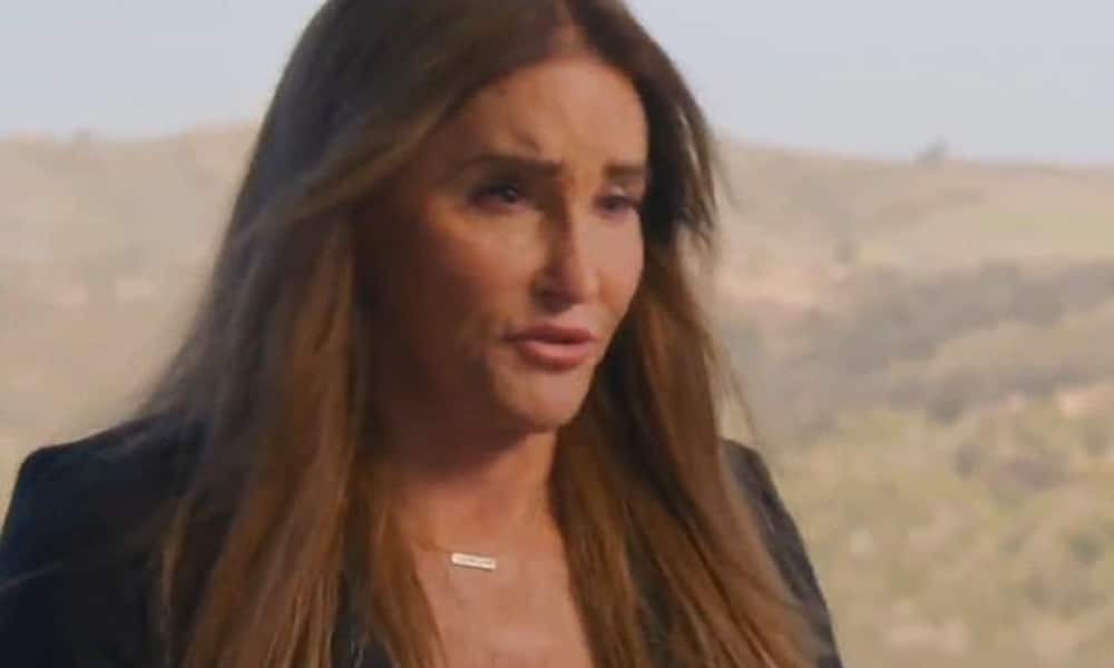 Caitlyn Jenner, with the dry Californian landscape behind her, speaks off to a camera facing her left