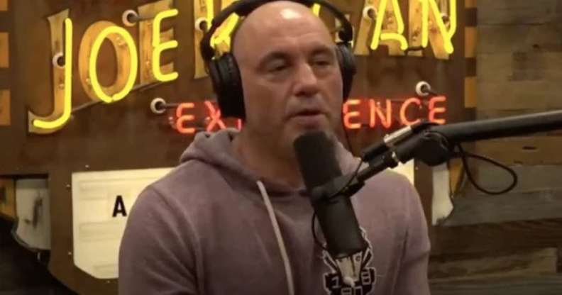 Joe Rogan in a hoodie behind the microphone