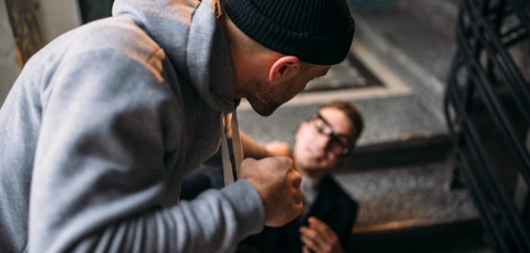 Street theif commits a robbery attack on a man in the entrance