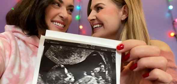 Rose and Rosie holding an ultrasound photo