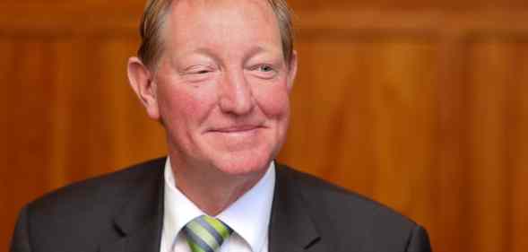 New Zealand MP Nick Smith smiles wearing a suit and tie