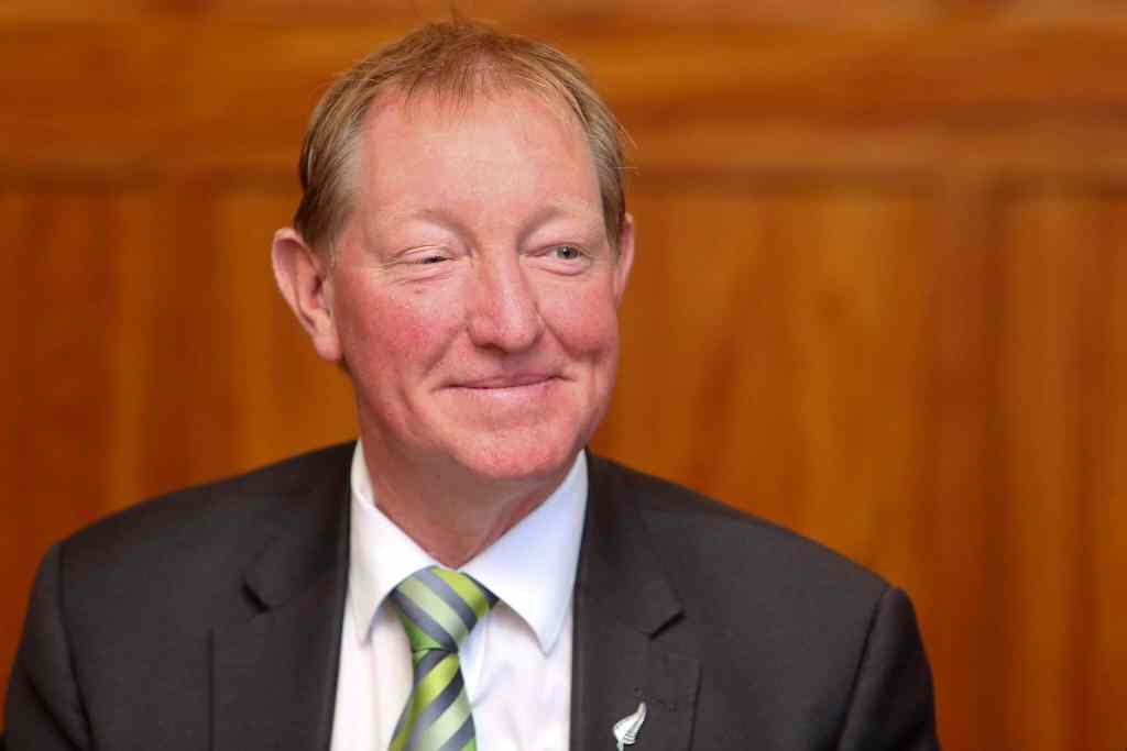 New Zealand MP Nick Smith smiles wearing a suit and tie