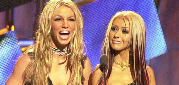 Britney Spears laughs as Christina Aguilera looks on at the MTV VMAs