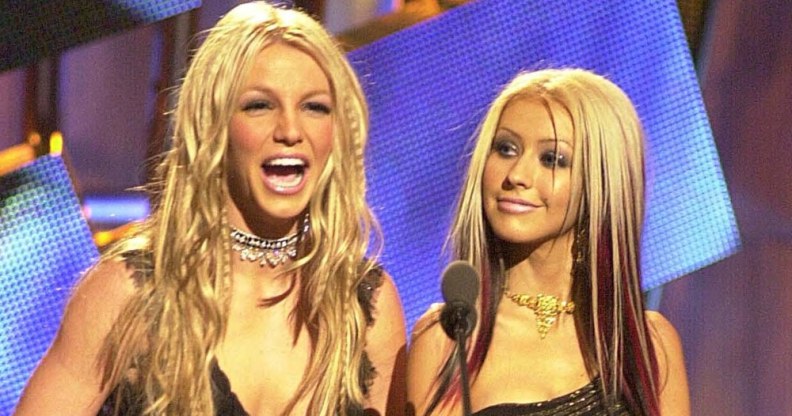 Britney Spears laughs as Christina Aguilera looks on at the MTV VMAs