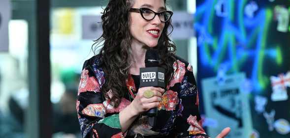 Jessica Stern wears a floral shirt as she speaks into a microphone