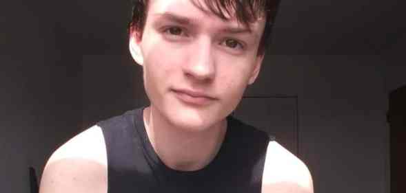 Poe Black poses to the camera in a black vest