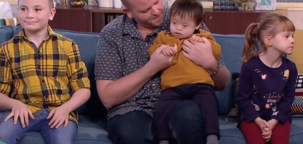 Ben Carpenter with three of his six adopted children