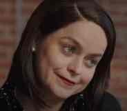 Tanya Manning in Karen, smiling as she cocks her head to the side