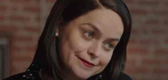 Tanya Manning in Karen, smiling as she cocks her head to the side