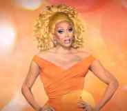 RuPaul in an orange dress