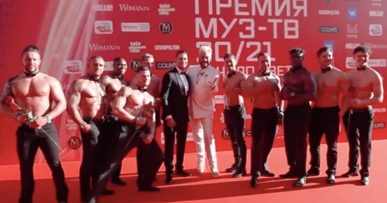 Russian rapper Dava and Filipp Kirkorov surrounded by muscular men