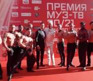 Russian rapper Dava and Filipp Kirkorov surrounded by muscular men