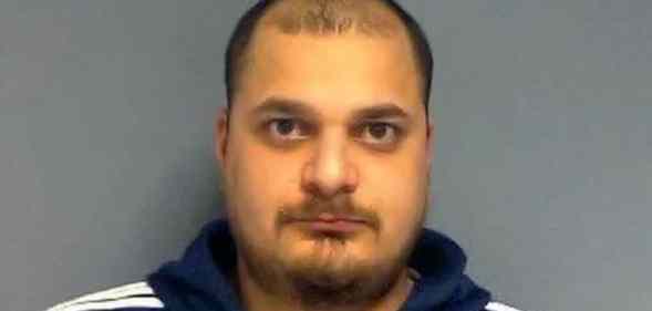 A mugshot of Suhel Sood in a black tracksuit