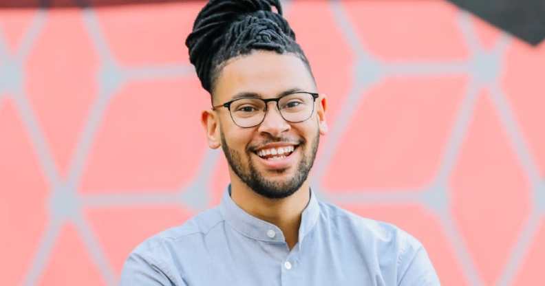 Jalen McKee-Rodriguez smiles in a blue button-up shirt