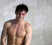 Tom Daley steps out of the pool shirtless