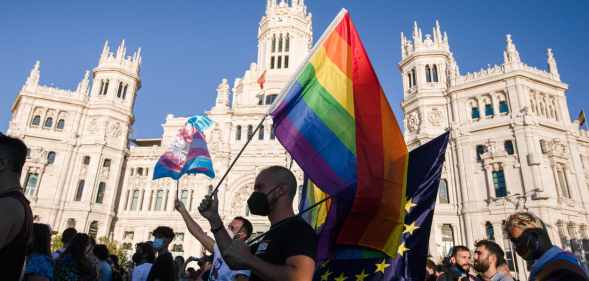 A protester waves a Pride flag in Madrid, Spain