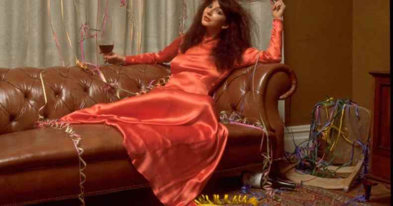 Musician Kate Bush posed on a sofa covered with party streamers in promotion of her one-off Christmas television special. (TV Times via Getty)