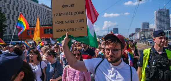 Polish LGBT activist Bartosz Staszewski holds a sign saying 'LGBT free zones'