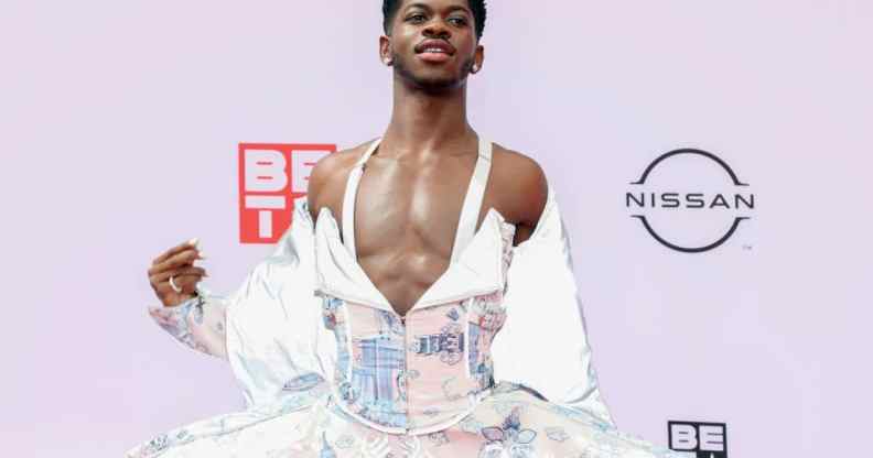 Lil Nas X poses for a photograph at the BET Awards in a flowing dress