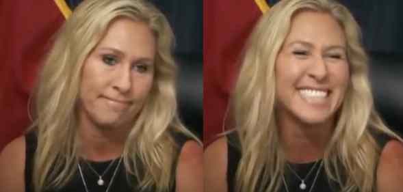 Marjorie Taylor Greene laughs at a press conference