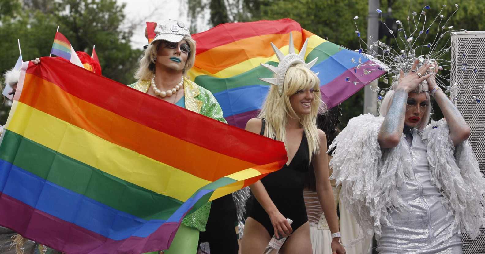 Pride-goers waving rainbow flags in Kyiv