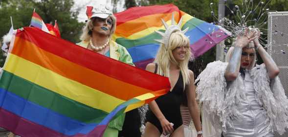 Pride-goers waving rainbow flags in Kyiv