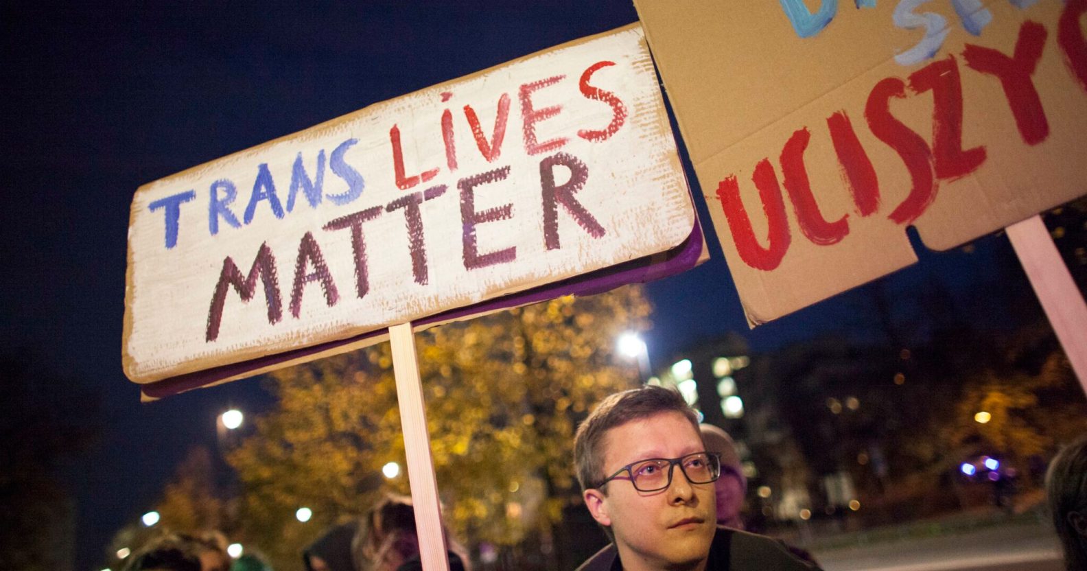 Protestor holds 'Trans Lives Matter' placard