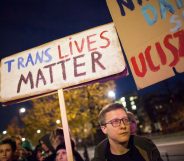 Protestor holds 'Trans Lives Matter' placard