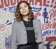 Chelcee Grimes poses in front of football graffiti artwork at FIFA