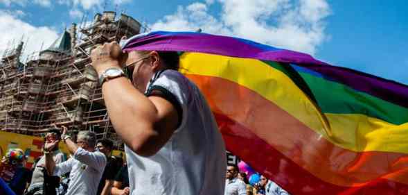 A person holds an LGBT+ Pride flag during the Antwerp Pride event in 2019 the pride march is used to stand up to homophobia and transphobia as well as celebrate the LGBT+ community in Belgium